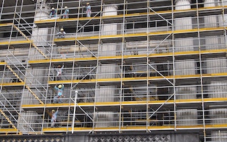 Workers on a scaffolding on a construction site in Singapore